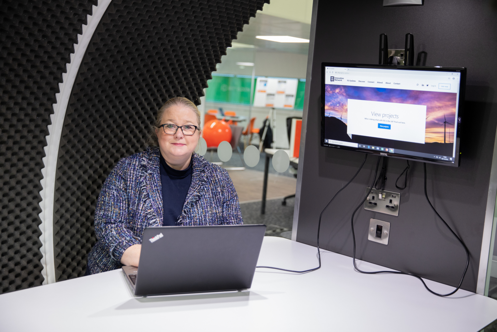 A woman sat in front of a laptop