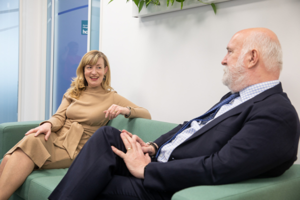 Two people chatting on a sofa