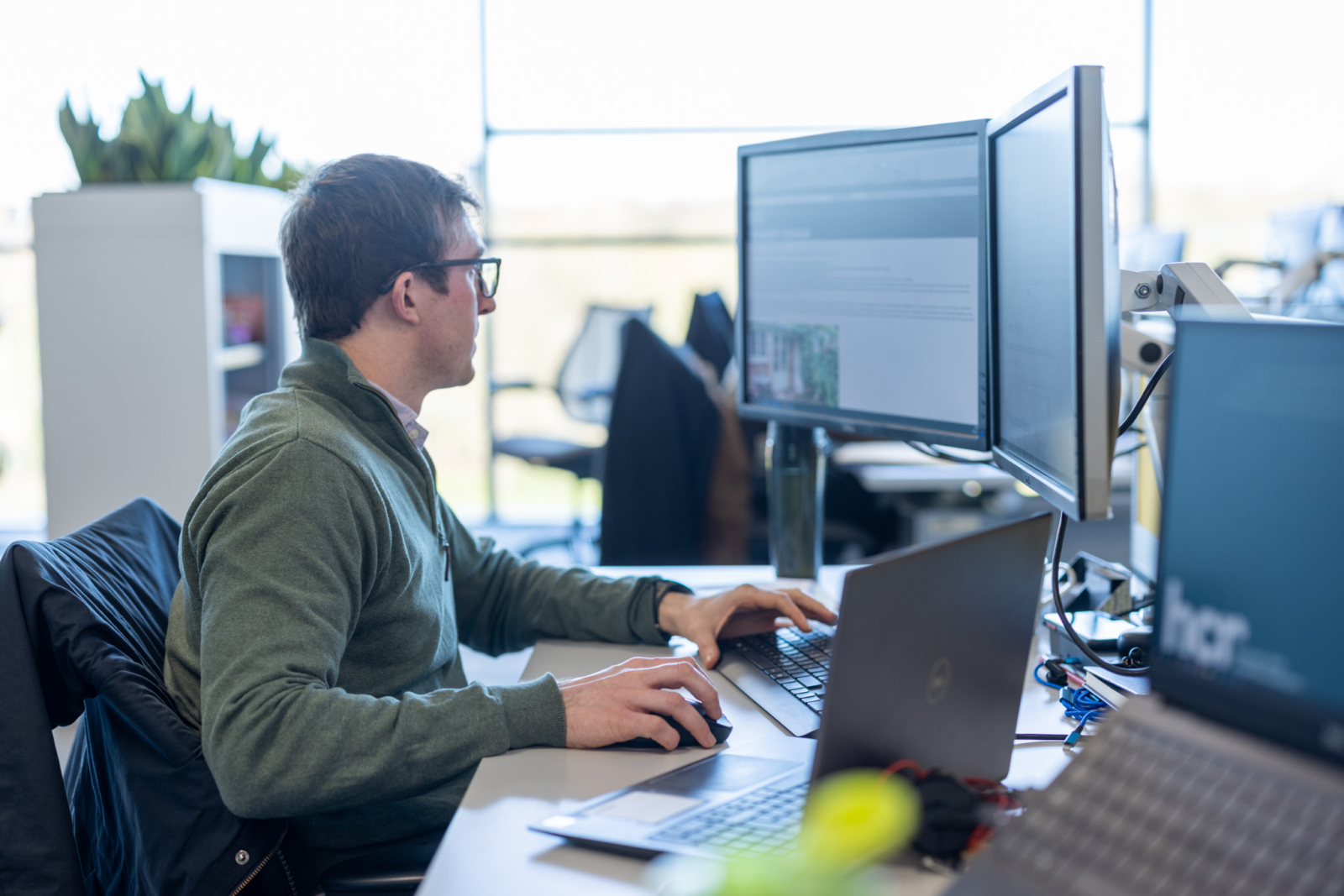 A man working on a computer, looking at the screen