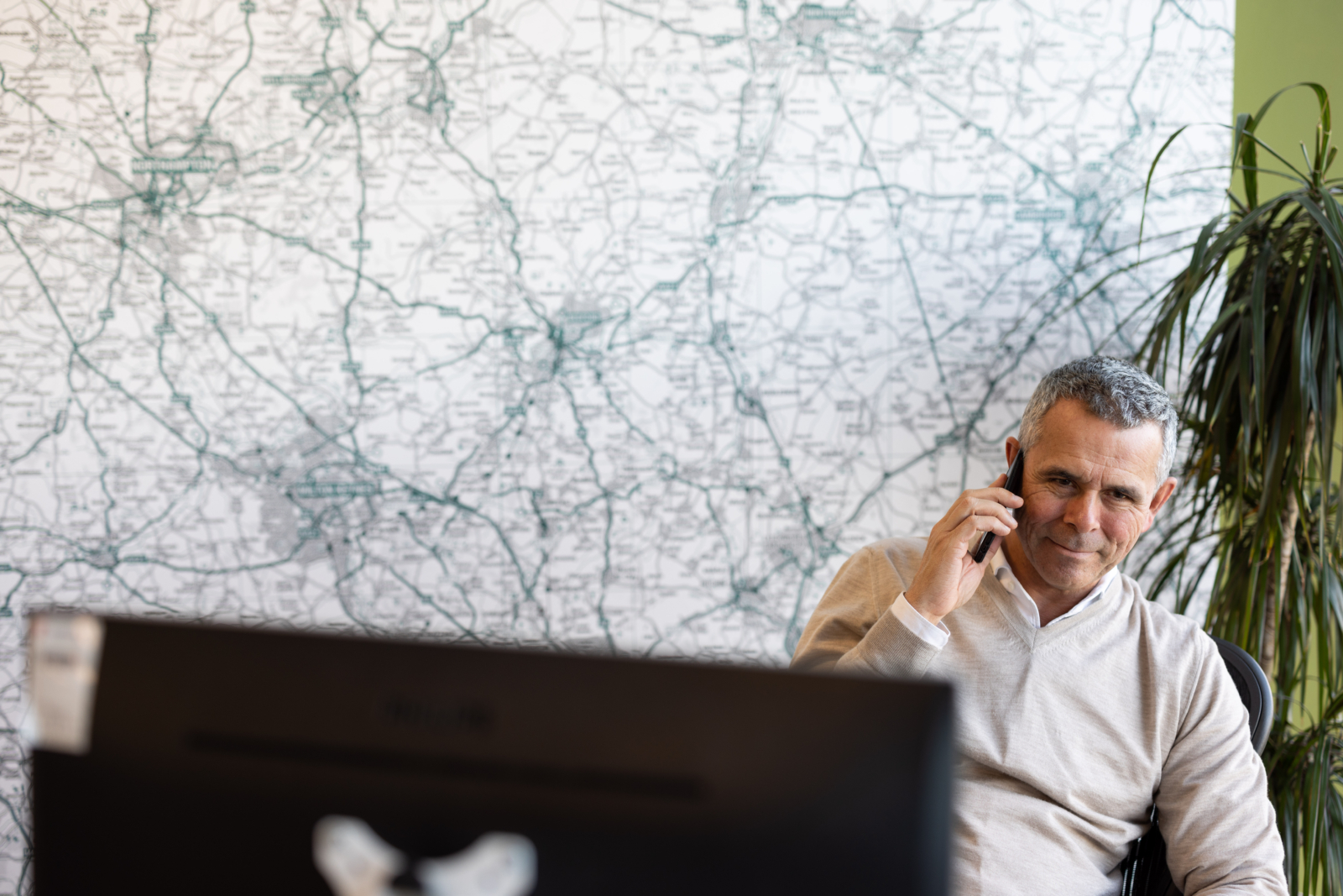 A member of the Intellectual Property team talking to a client on the phone and smiling