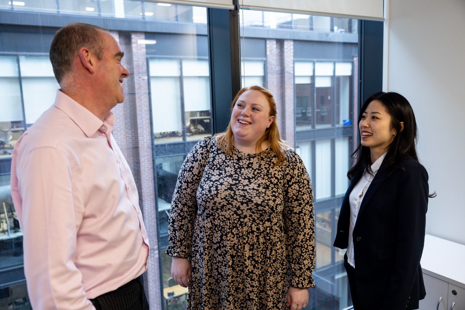 team meeting between 2 women and a man