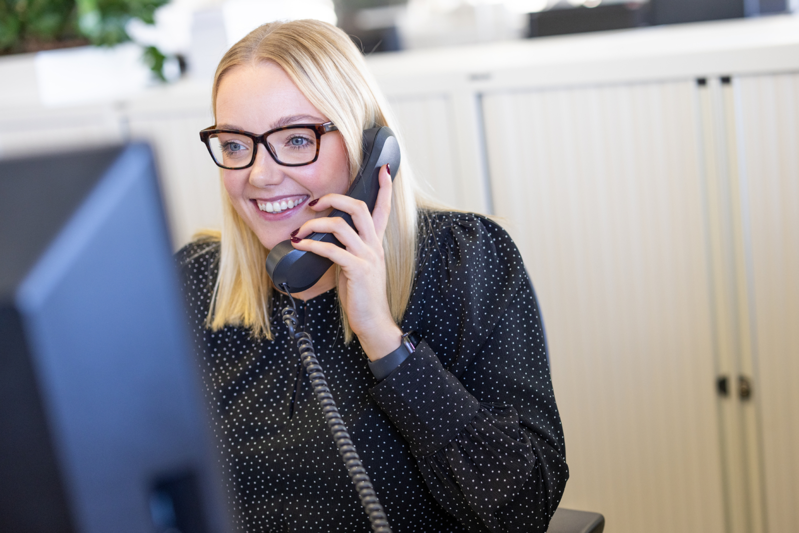 One of our staff on their phone talking to a client