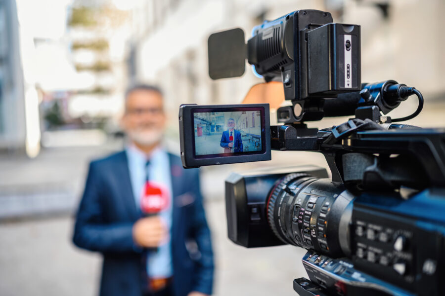 A reporter being filmed in public