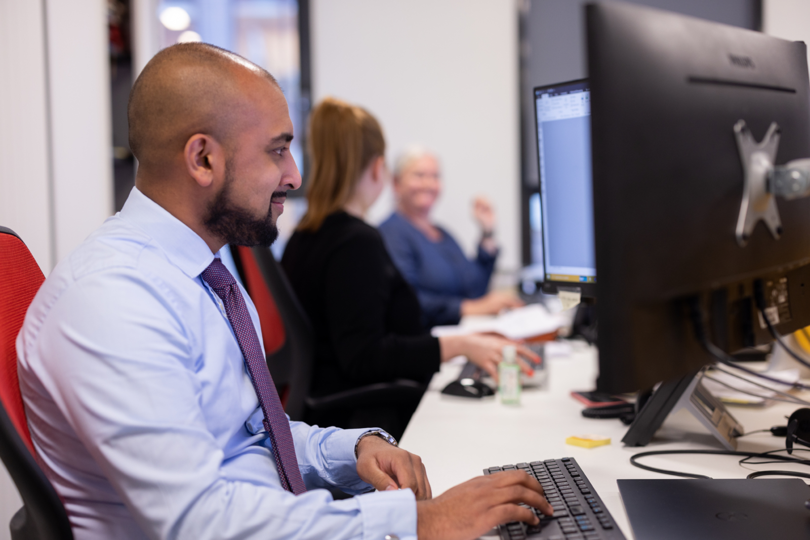 Man sat at desk working on computer