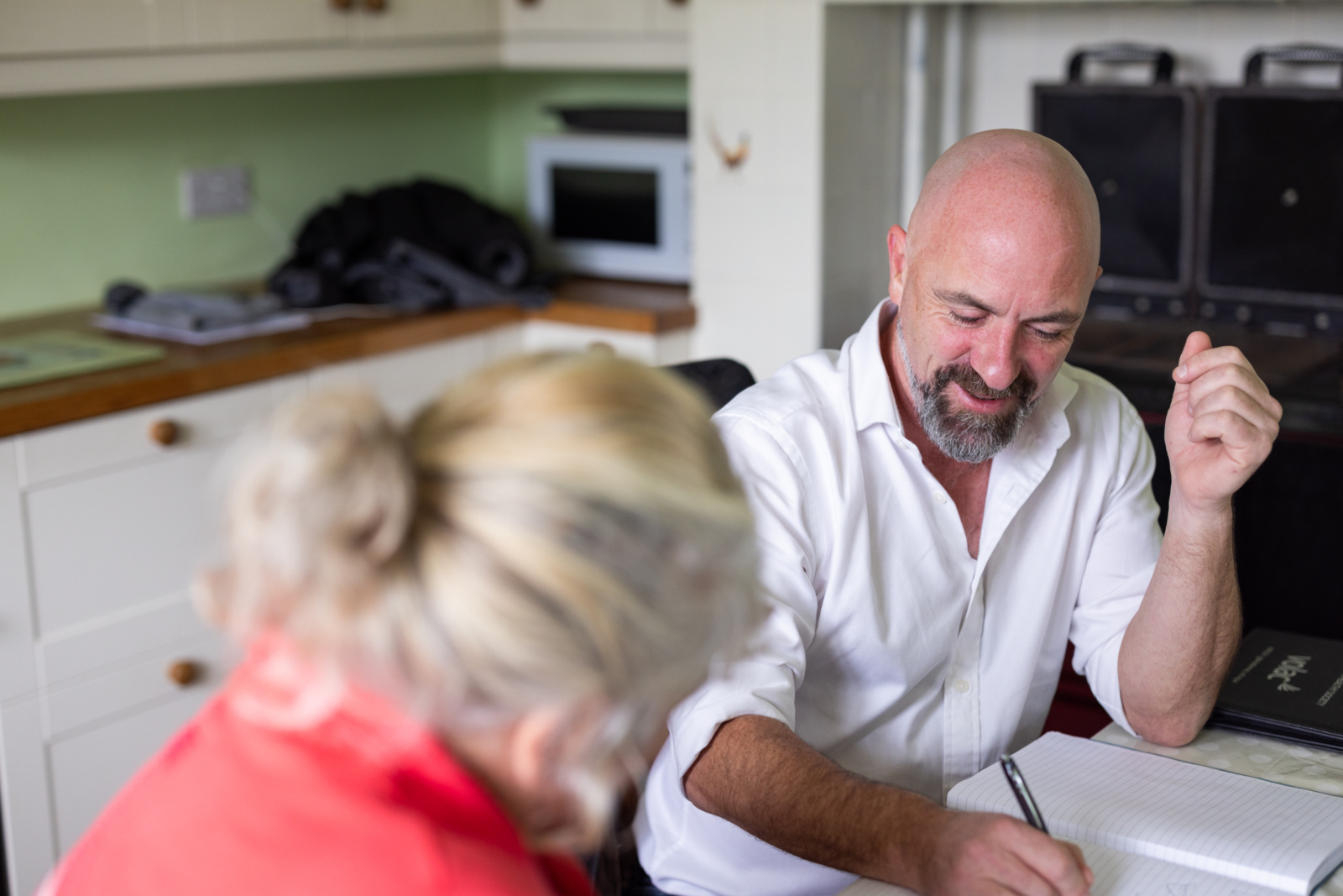 one of our solicitors sat at a table discussing work with a client