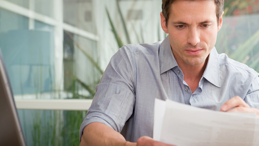 Man looking at a piece of paper