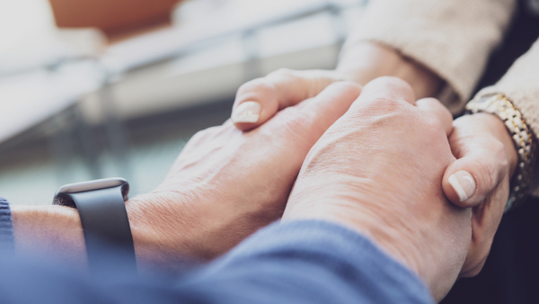 Two people holding hands