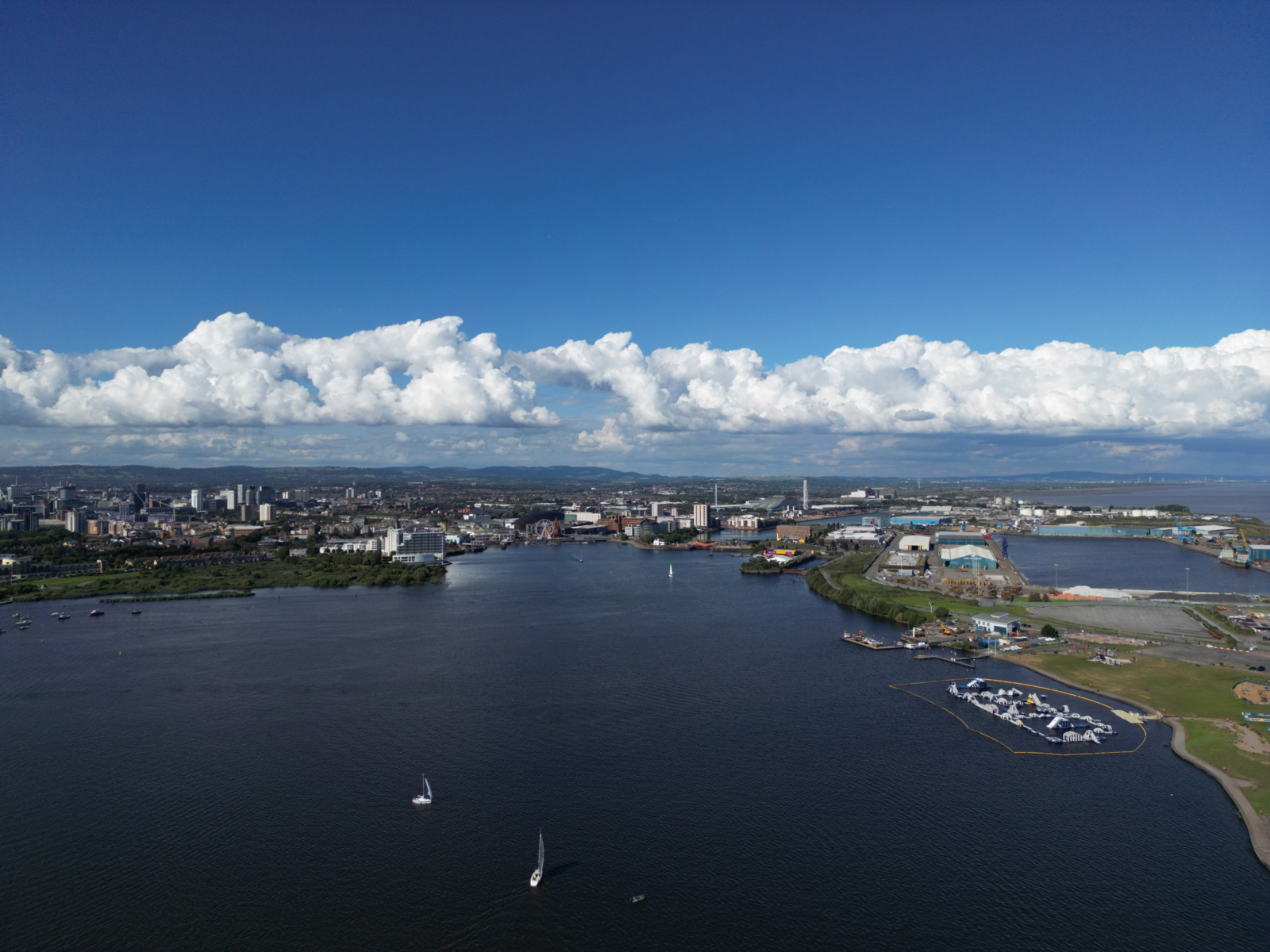 An image of land, body of water and clouds