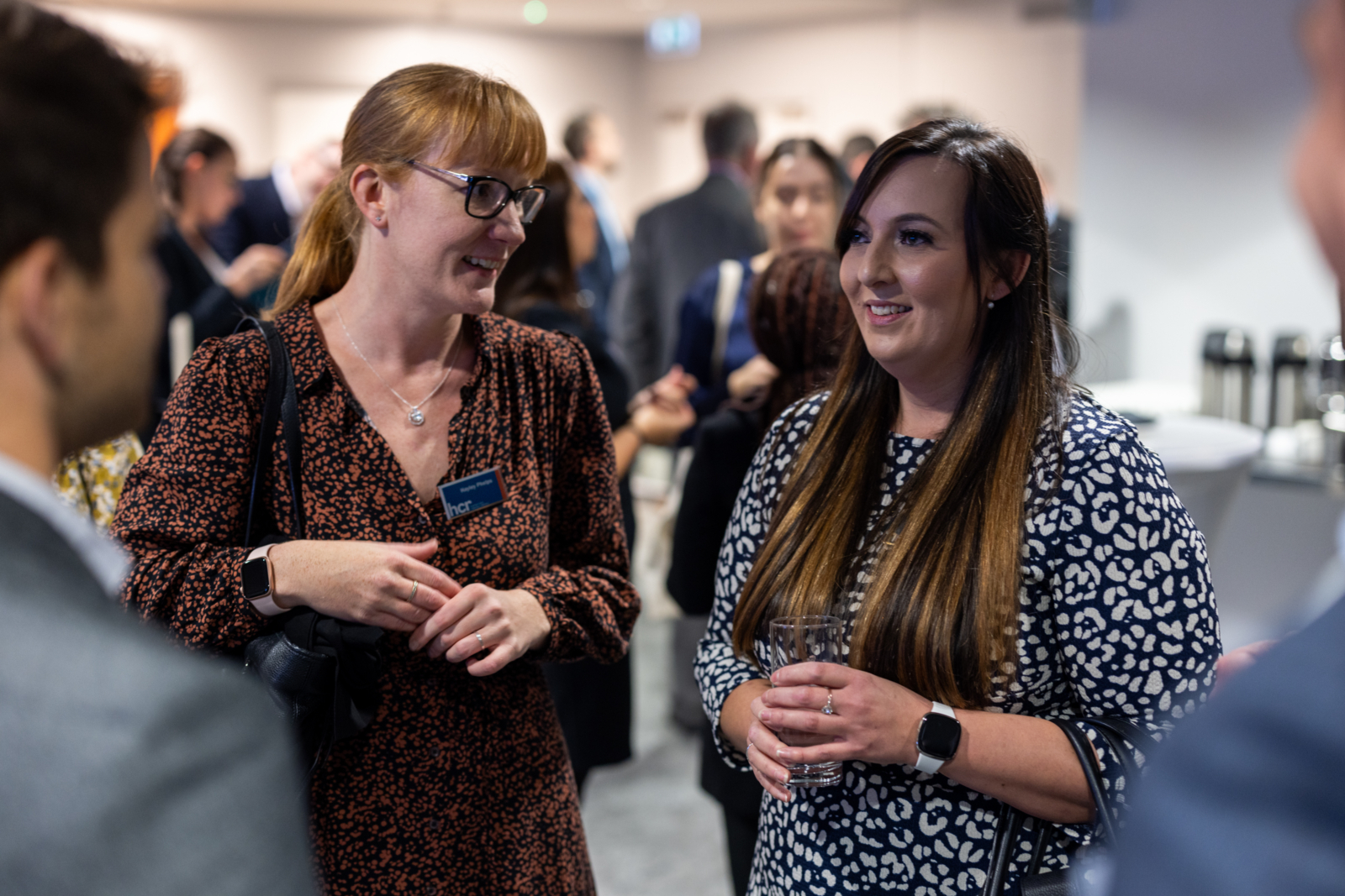 Two people talking at a networking event