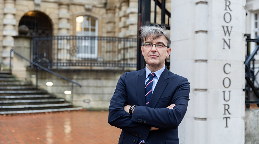 London lawyer standing outside a courtroom