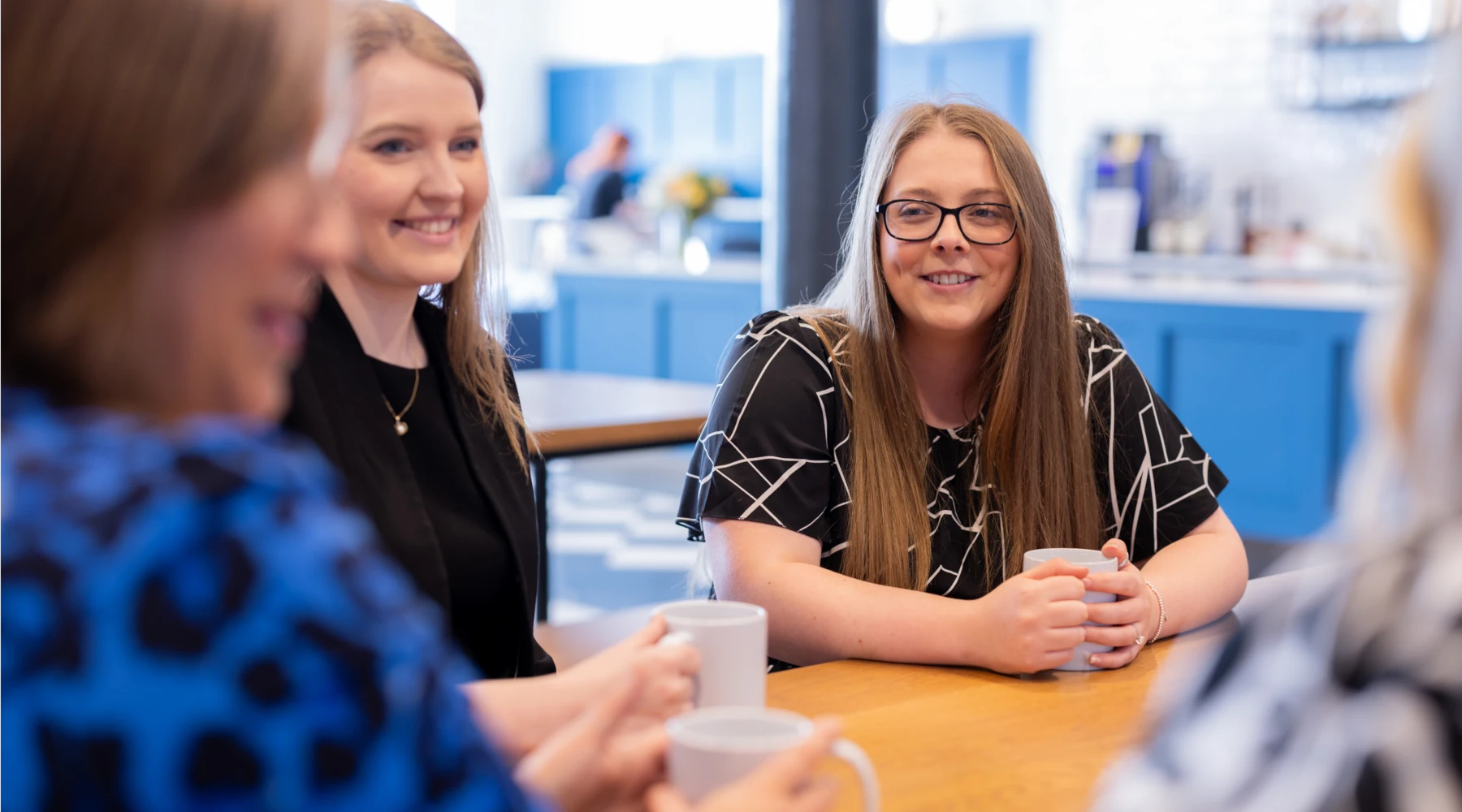 Solicitors sitting at a table having a discussion