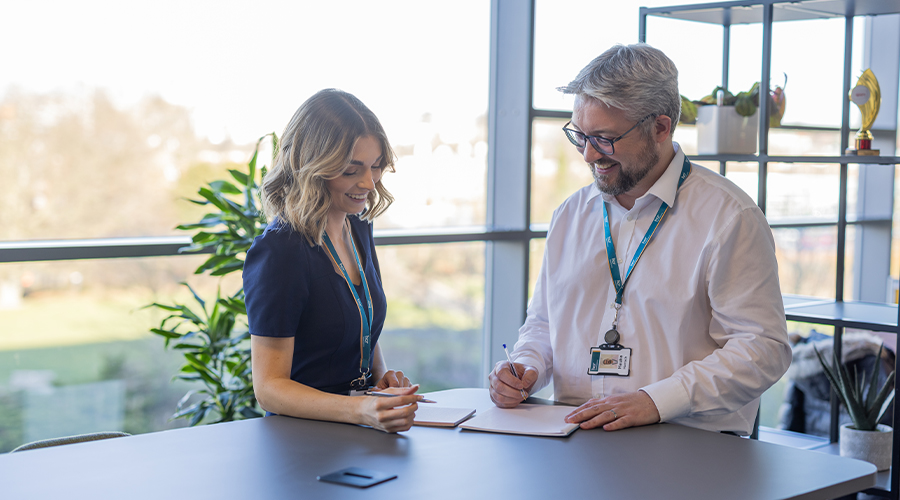 Lawyer and client looking over documents and smiling