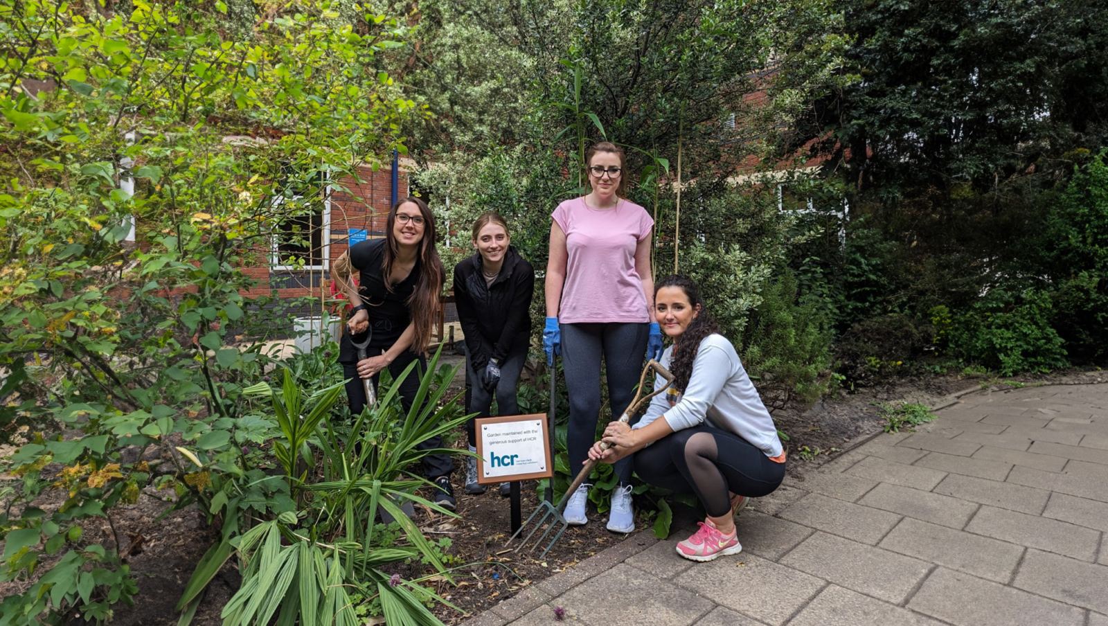 A group of HCR staff tending to the Oncology Garden at Cheltenham Hospital