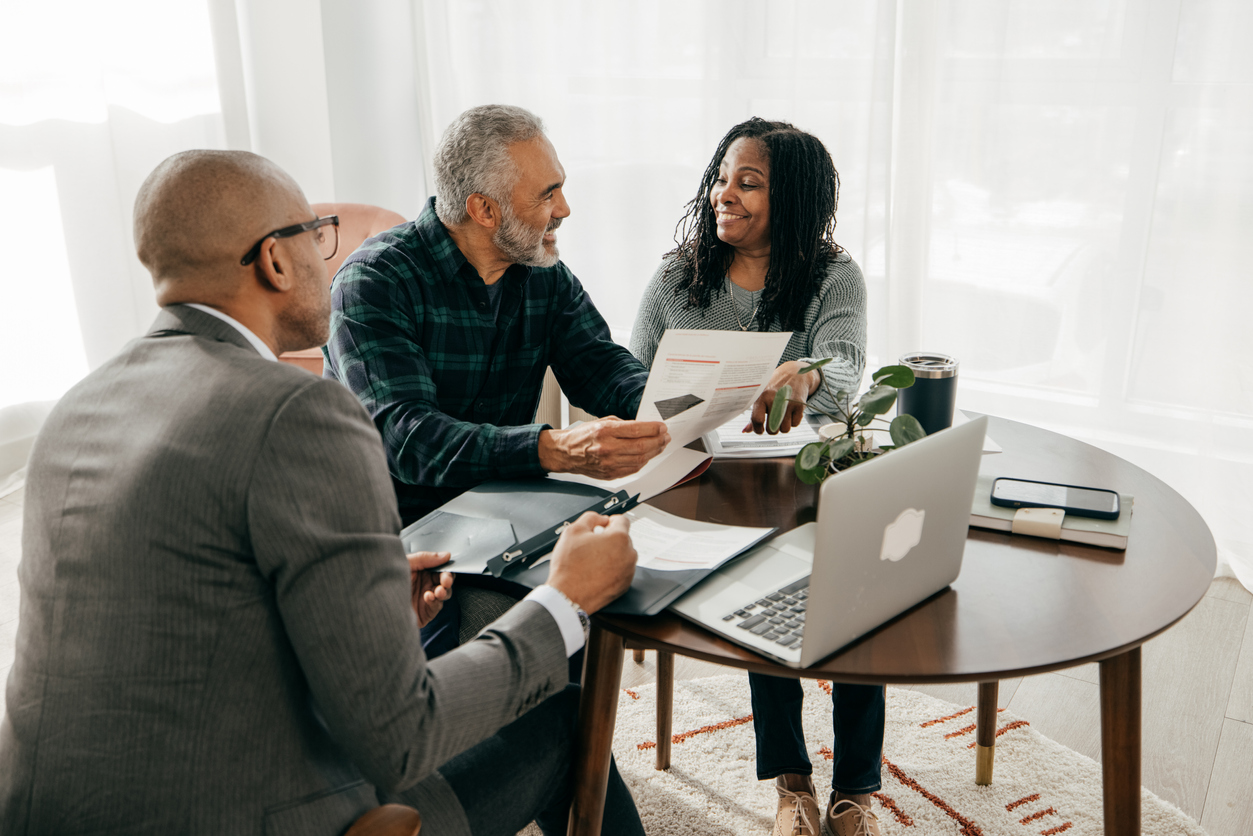 A lawyer discussing complex tax advice with a couple.