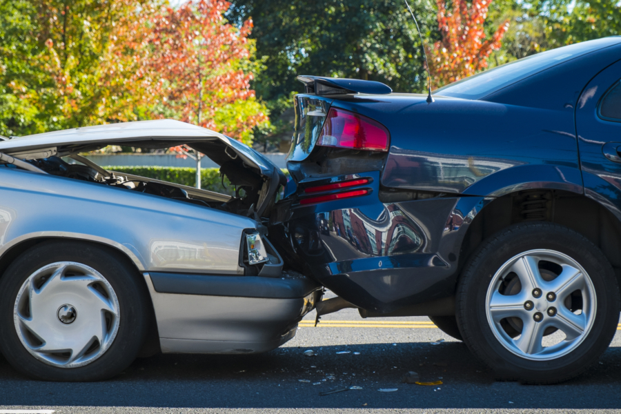 Silver car crashed into the back of a black car