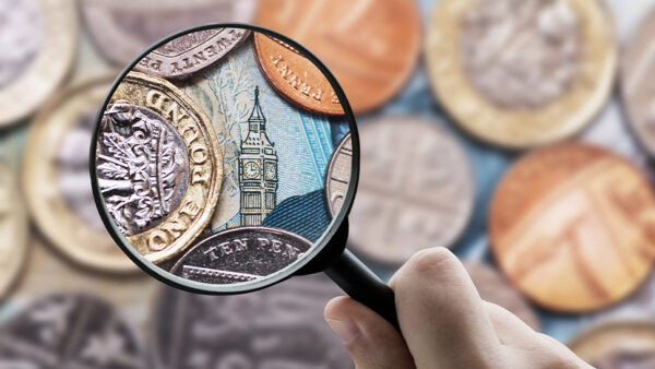 Image of a magnifying glass examining british coins