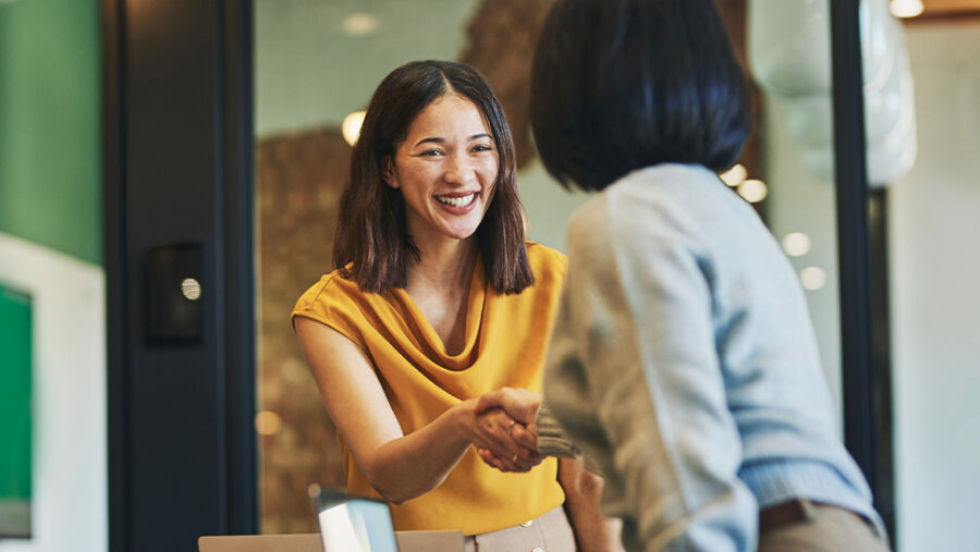 Image of two people greeting