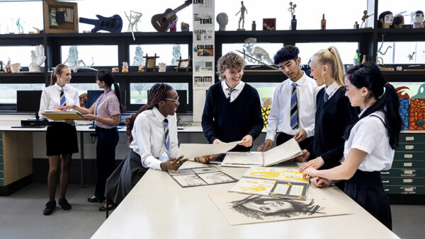 Image of school students around a table