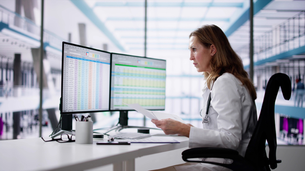 An NHS nurse using a computer for data protection strategy