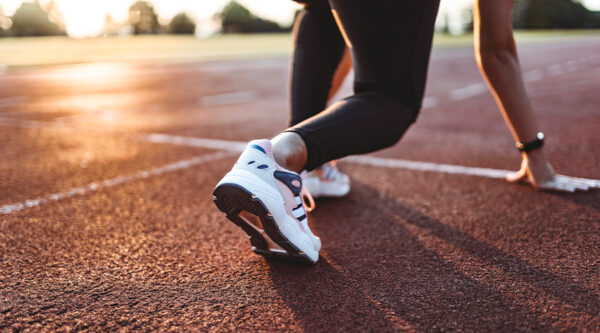 A photo of someone preparing on a sprinting racetrack,