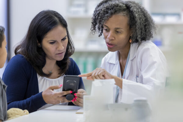 Healthcare staff members reviewing a phone