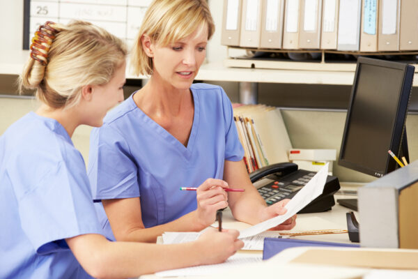 Two nurses viewing a report