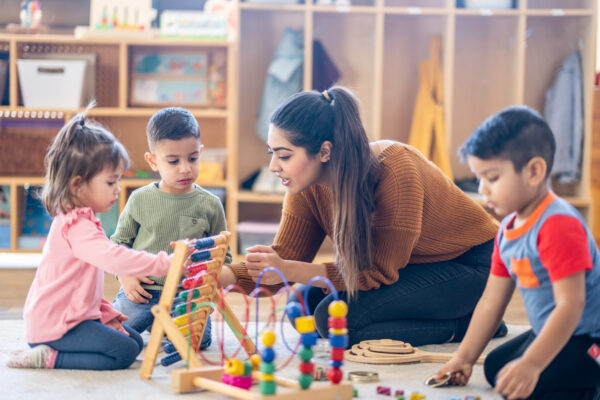 Photo of a woman with toddlers at a day nursery