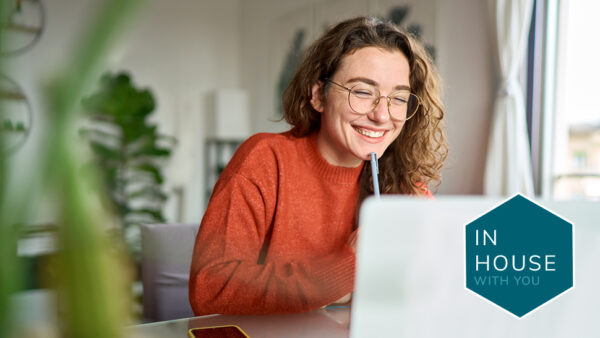 Woman at computer with IHL logo