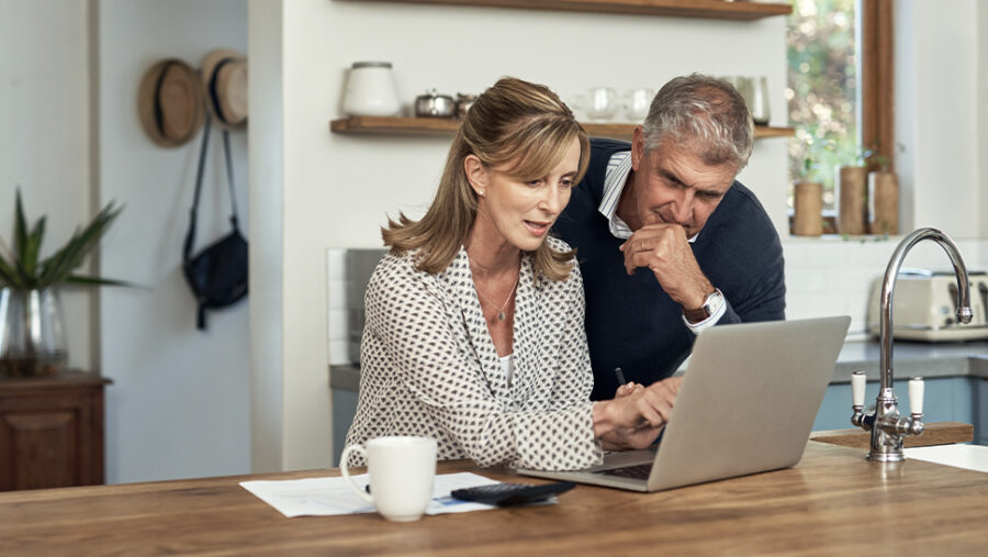 Photo of a couple using a laptop