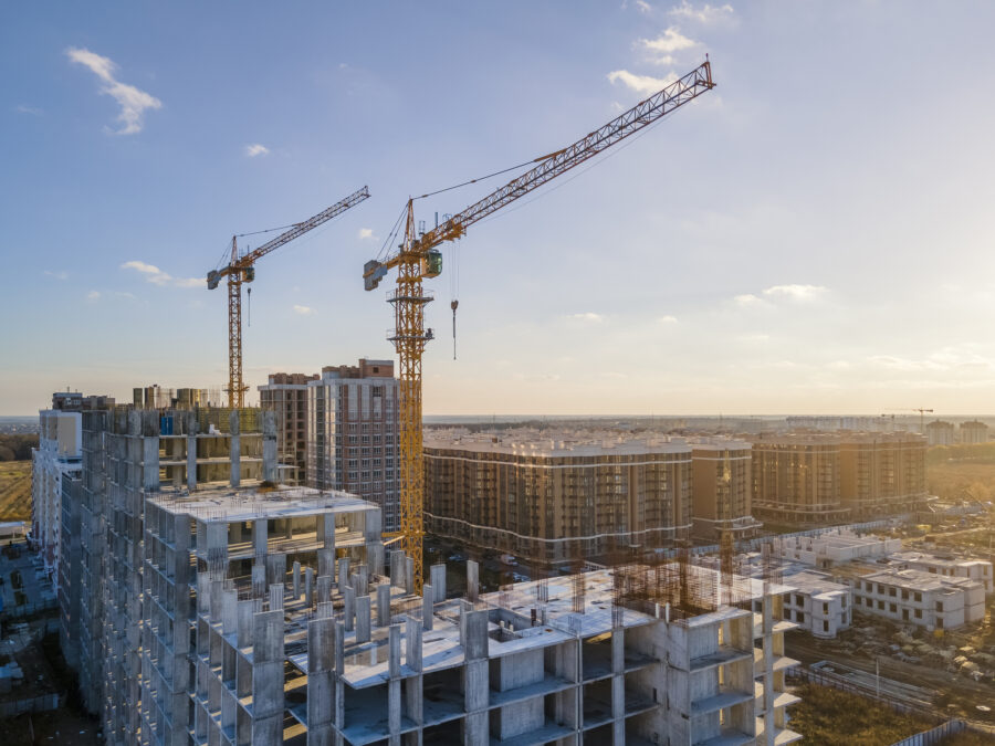 A city skyline with cranes and construction.