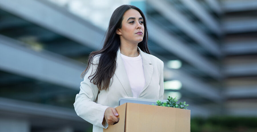 Image of a lady carrying a box of belongings