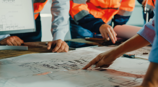 Builders checking a plan