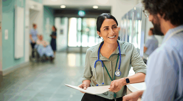 Healthcare professionals chatting in a hospital hallway