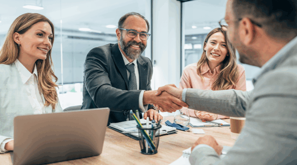 People shaking hands after a deal