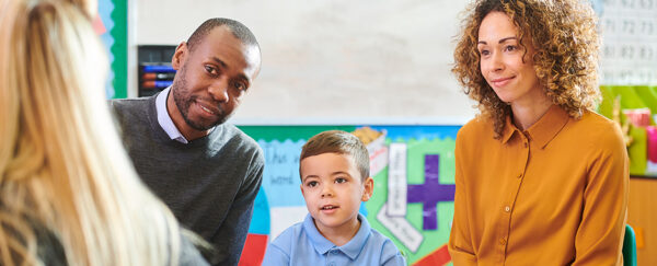 family talking to the teacher at school