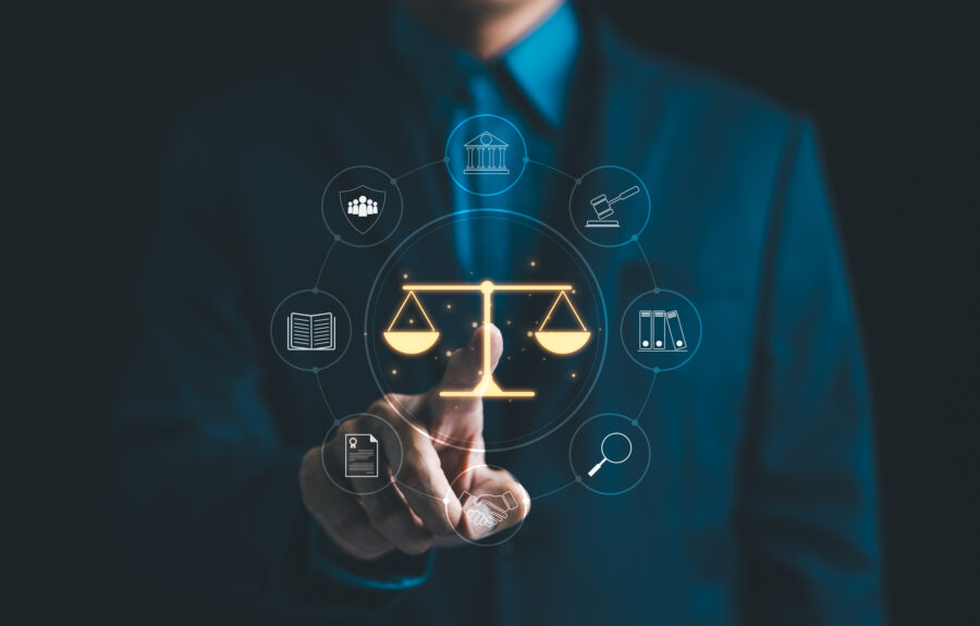 A person touching a button with a graphical image of the scales of justice