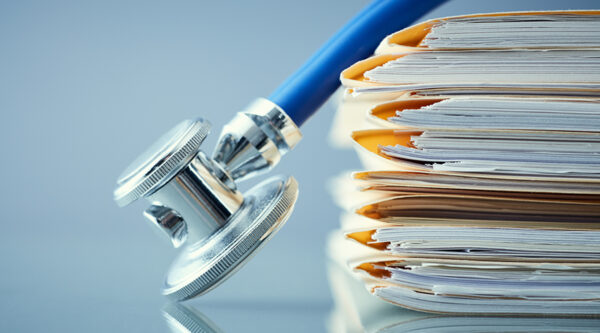 A picture of a stethoscope on a stack of papers