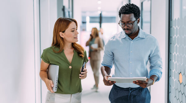 Two technology employees discussing an issue