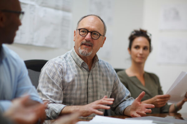 A photo of a man at a charity meeting