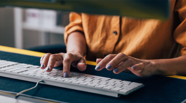 A person typing on a keyboard
