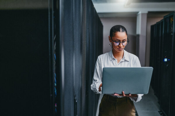 A picture of a tech engineer holding a laptop