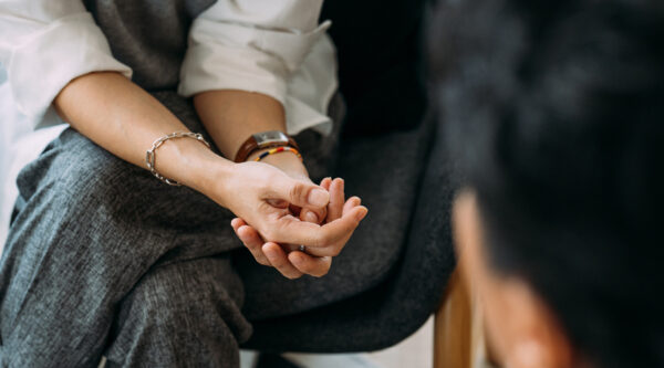 A picture of rubbing hands as someone talks to a specialist
