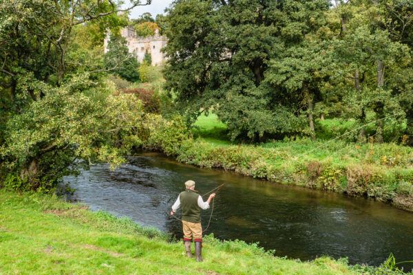 A fisherman by a river
