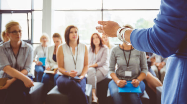 Employees listening to a meeting
