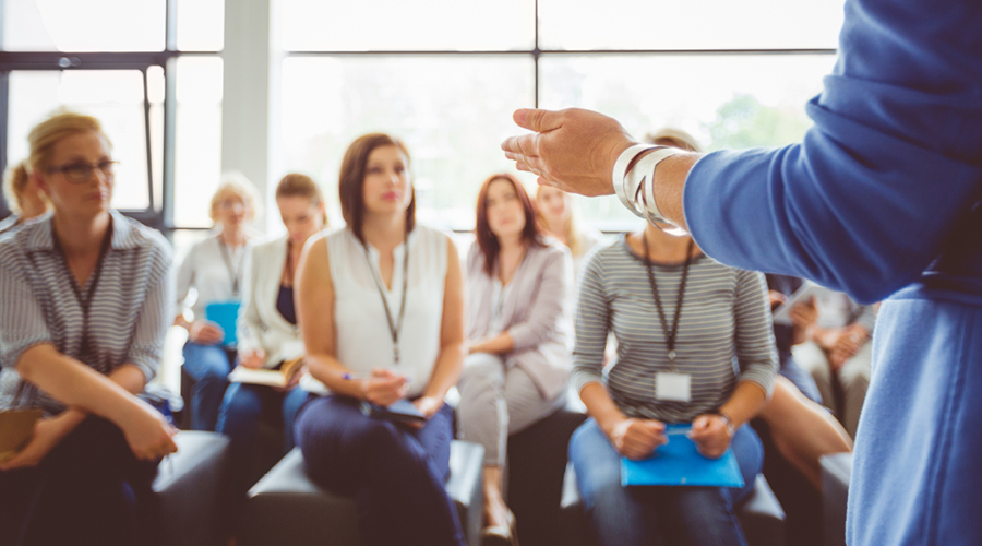 Employees listening to a meeting