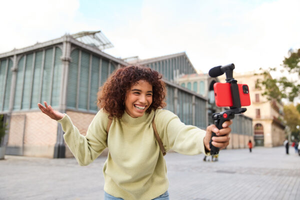 Happy young woman vlogger creating video content for social media