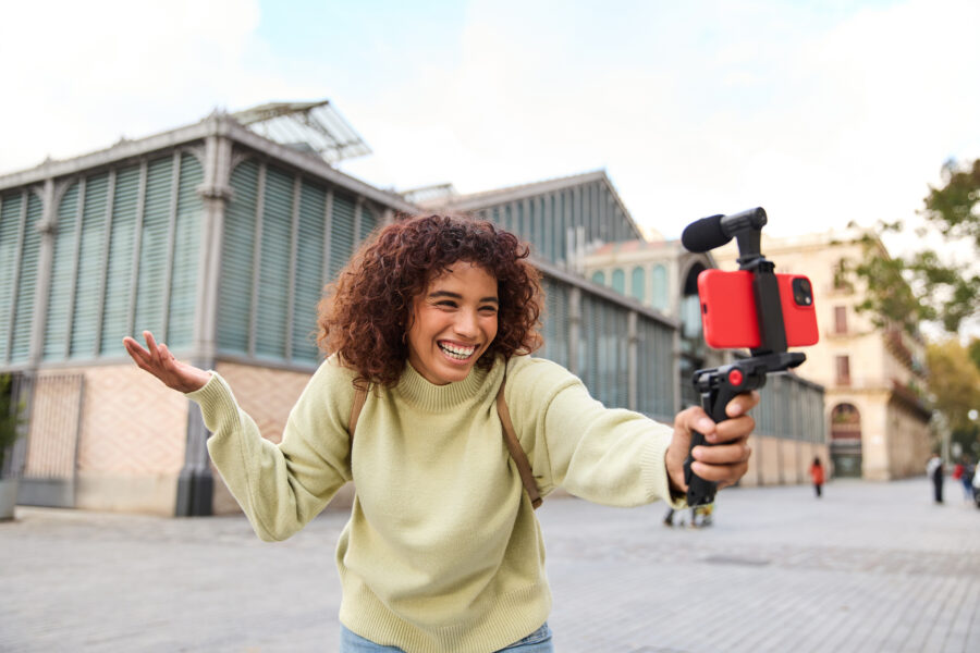 Happy young woman vlogger creating video content for social media