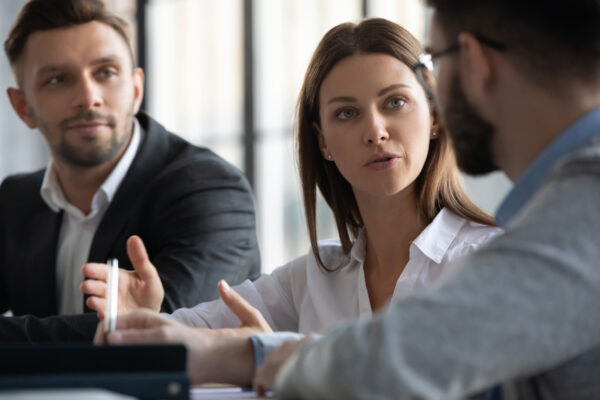 Three people having a meeting about an inquiry