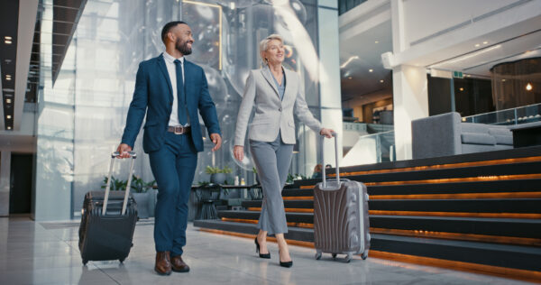 Two businesspeople arriving at an airport