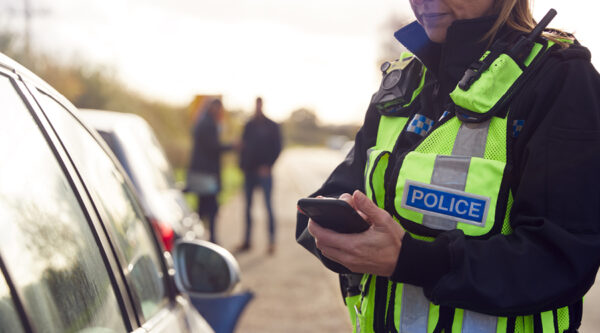 A police officer stopping by a car